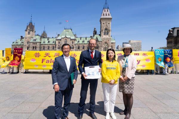 Conservative MP Arnold Viersen poses with Falun Gong adherents at Parliament Hill in Ottawa on May 10, 2022. (Evan Ning/The Epoch Times)