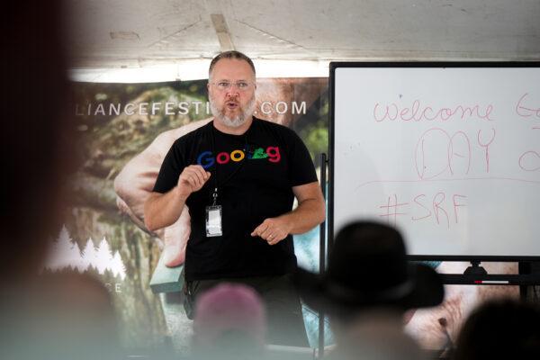 Jack Spirko, host of The Survival Podcast, speaks at the Self-Reliance Festival in Camden, Tenn., on June 12, 2022. (Charlotte Cuthbertson/The Epoch Times)