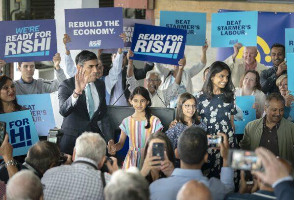 Conservative leadership contender Rishi Sunak, with daughters Krishna, Anushka, and wife Akshata Murthy, during a visit to Vaculug tyre specialists at Gonerby Hill Foot, Grantham, on July 23, 2022. (Danny Lawson/PA Media)