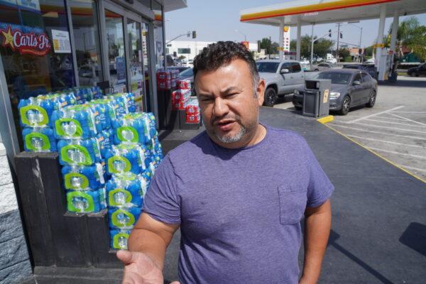Francisco Gonzalez, owner of F.J. Trucking Services in Palmdale, Calif., stands outside a truck stop in Long Beach, Calif., on July 26, 2022. Gonzalez says he fears losing his status as an independent truck owner-operator.  (Allan Stein/The Epoch Times)