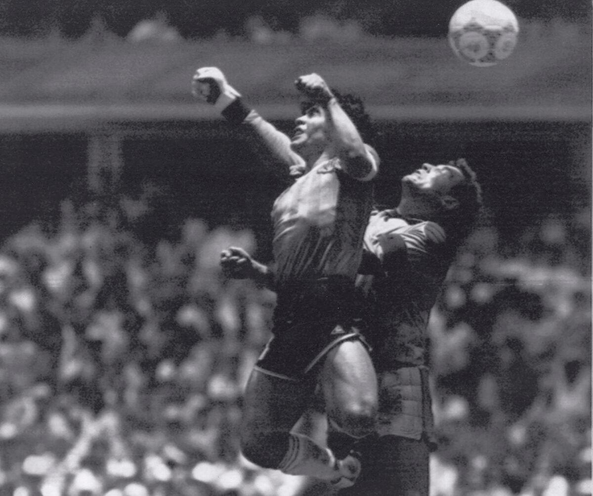Argentina's Diego Maradona (L) beats England goalkeeper Peter Shilton to a high ball and scores his first of two goals in a World Cup quarterfinal in Mexico City on June 22, 1986. (El Grafico, Buenos Aires/AP Photo)