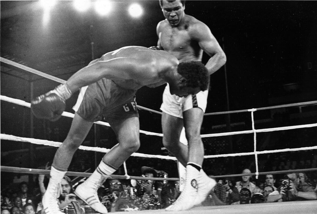 Challenger Muhammad Ali (R) watches as defending world champion George Foreman goes down to the canvas in the eighth round of their WBA/WBC championship match in Kinshasa, Zaire, Congo, on Oct. 30, 1974. (Richard Drew/AP Photo)