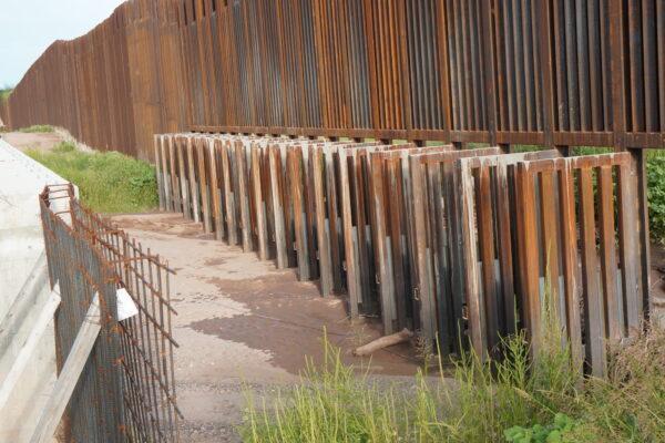 More irrigation gates are left open in the border wall fence near Bisbee, Ariz., on Aug. 24. (Allan Stein/The Epoch Times)