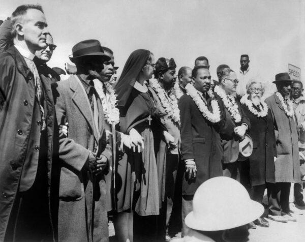 Civil rights demonstrators, led by Dr. Martin Luther King (5th R), civil rights activist Ralph Abernathy (5th L), John Lewis (3rd L) and other civil and religious leaders, make their way from Selma to Montgomery on March 22, 1965, in Alabama, on the third leg of the Selma to Montgomery marches. (AFP via Getty Images)