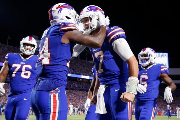 Buffalo Bills' Stefon Diggs, second from left, celebrates with quarterback Josh Allen, second from right, after they connected for a touchdown during the second half of an NFL football game against the Tennessee Titans in Orchard Park, New York on Sept. 19, 2022. (Jeffrey T. Barnes/AP Photo)