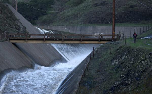 Water flows down the spillway at Nicasio Reservoir after days of rain have brought the reservoir to near capacity in Nicasio, Calif., on Jan. 9, 2023. (Justin Sullivan/Getty Images)