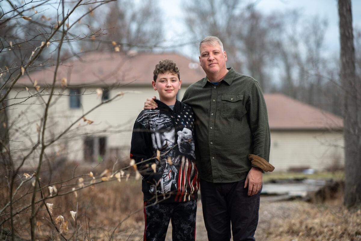 Mark Houck with his son Mark Jr., in the backyard of their home in Kintnersville, Pa., on March 17, 2023. (Samira Bouaou/The Epoch Times)