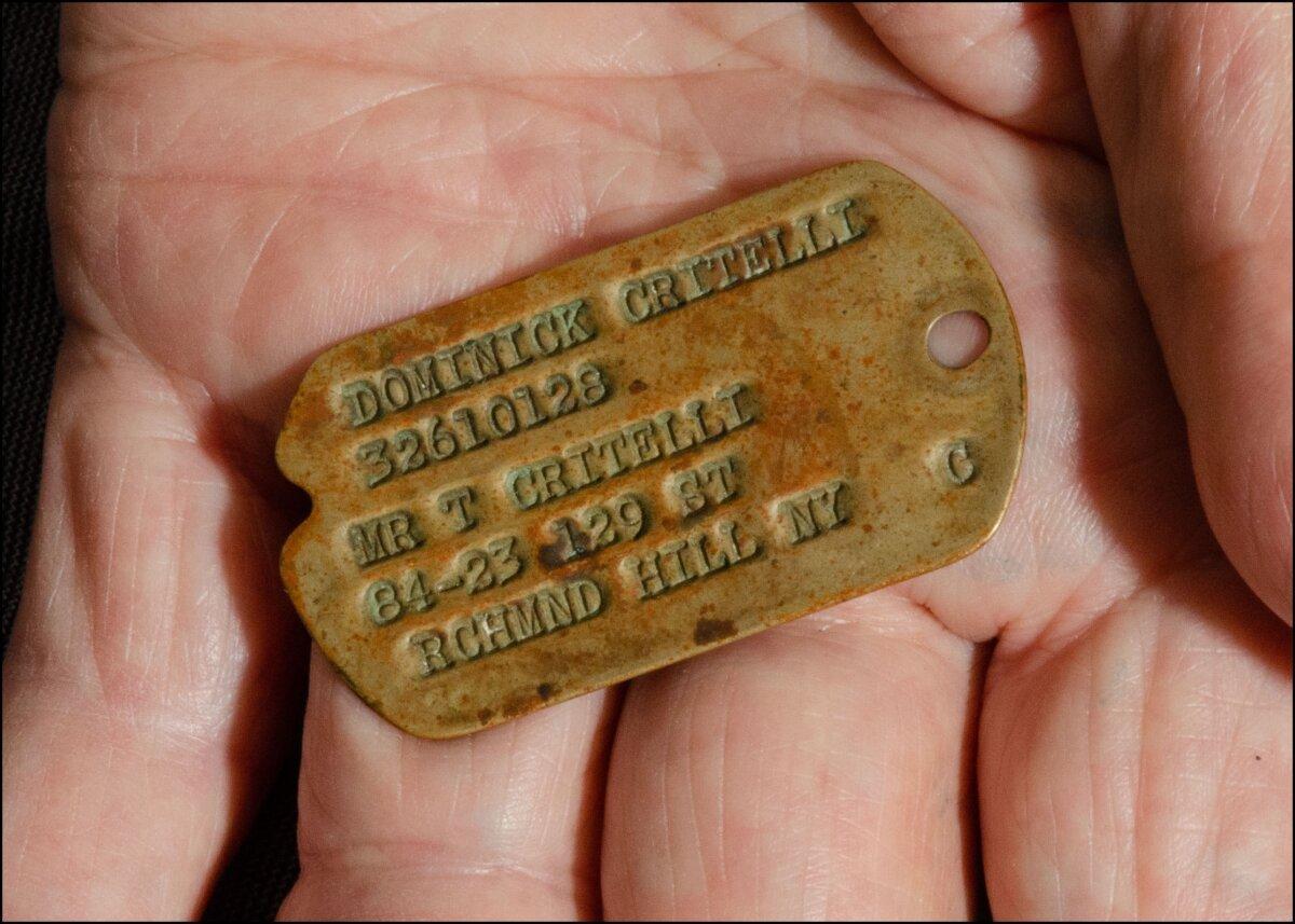 Critelli holds his one-surviving dog tag from his service in World War II. (Dave Paone)