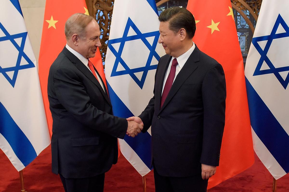 Israel's Prime Minister Benjamin Netanyahu and Chinese leader Xi Jinping shake hands ahead of their talks at Diaoyutai State Guesthouse in Beijing, on March 21, 2017.  (Etienne Oliveau/AFP via Getty Images)