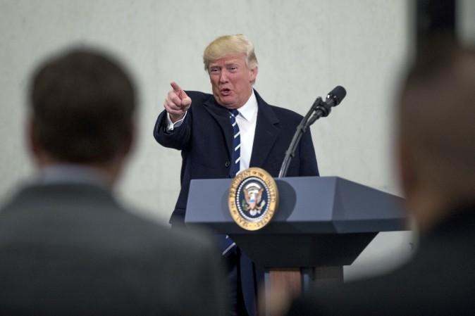 President Donald Trump points to a member of the audience after speaking at the Central Intelligence Agency in Langley, Va., Saturday, Jan. 21, 2017. (AP Photo/Andrew Harnik)