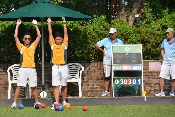 Neil Harrington (in front) from Hong Kong Football Club B team watches anxiously a bowl delivered by his teammate in the league match against Kowloon Cricket Club.. He lost the match by a shot allowing KCC to edge closer to league leaders Hong Kong Football Club A. (Stephanie Worth)