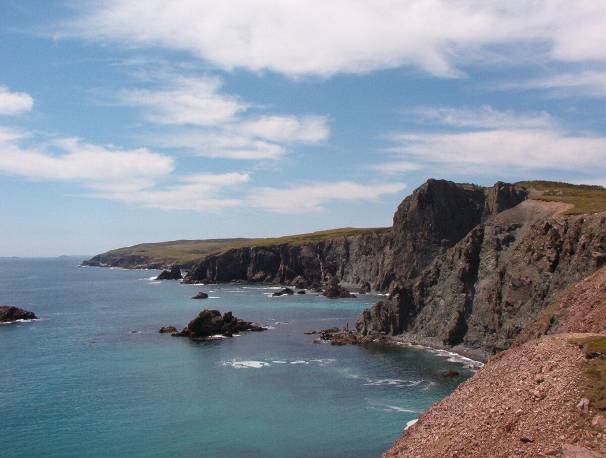 View of the USS Truxtun wreck site at Chamber Cove, with the U.S.S. Pollux wreck site at Lawn Point Head in the distance. The combination of extremely rough weather, strict radio silence, an incorrectly plotted course, and rigid adherence to a base course set by naval authorities led to the disaster in February 1942. (Dale Jarvis/Heritage Foundation of Newfoundland and Labrador)