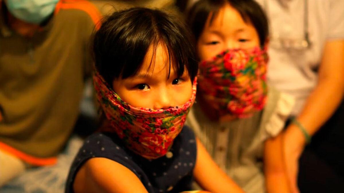 Young movie extras in masks in 2011's "Contagion." (Warner Bros.)