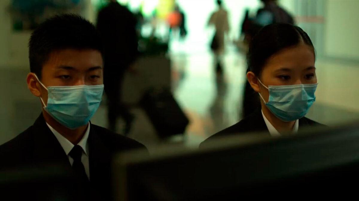 Movie extras in masks in 2011's "Contagion." (Warner Bros.)