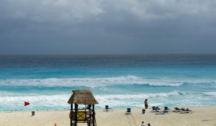 Tourists enjoy the beach during a windy day in Cancun, Mexico, on Dec. 1, 2010. (Omar Torres/AFP/Getty Images)