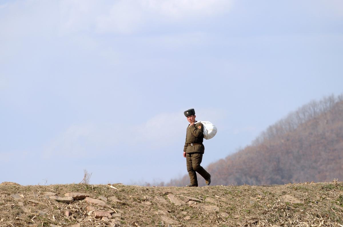 A North Korean soldier walks on the banks of the Yalu River at the North Korean town of Sinuiju across from the Chinese city of Dandong, northeastern Liaoning province on April 10, 2013. (Wang Zhao/AFP/Getty Images)