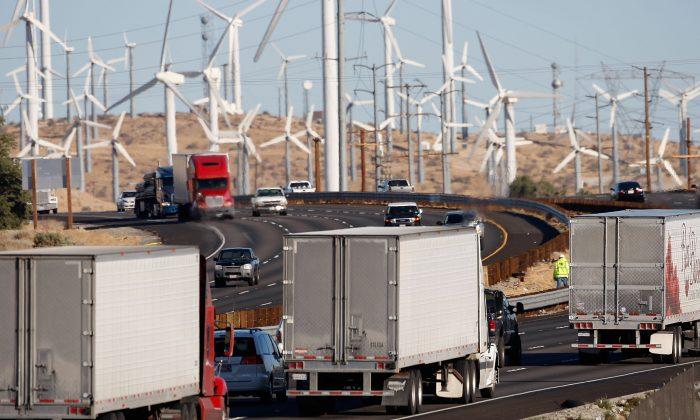 Trucks pass wind turbines alongside the freeway near Banning, Calif., on Dec. 8, 2009. (David McNew/Getty Images)