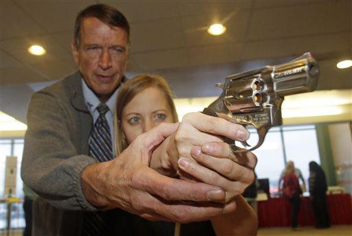 In this Dec. 27, 2012 file photo, Cori Sorensen, a fourth grade teacher from Highland Elementary School in Highland, Utah, receives firearms training with a .357 magnum from personal defense instructor Jim McCarthy in West Valley City, Utah. (AP Photo/Rick Bowmer)
