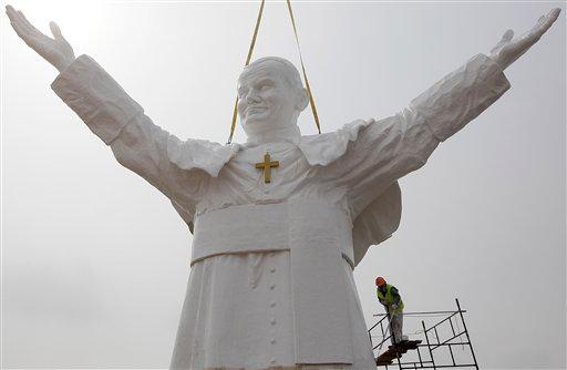 A worker adds finishing touches to a giant statue of the late Pope John Paul II being readied for unveiling in Czestochowa, Poland, on April 9, 2013. (AP Photo/Czarek Sokolowski)