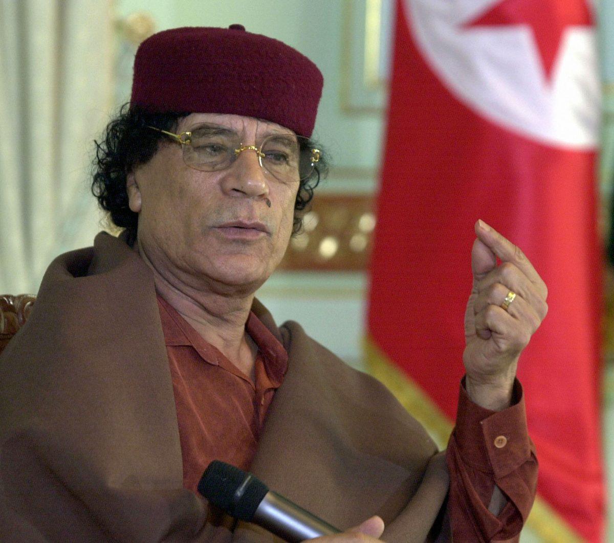 A file photo of late Libyan leader Moammar Gadhafi meeting with Tunisian parliamentarians on May 21, 2003. (Fethi Belaid/AFP/Getty Images)