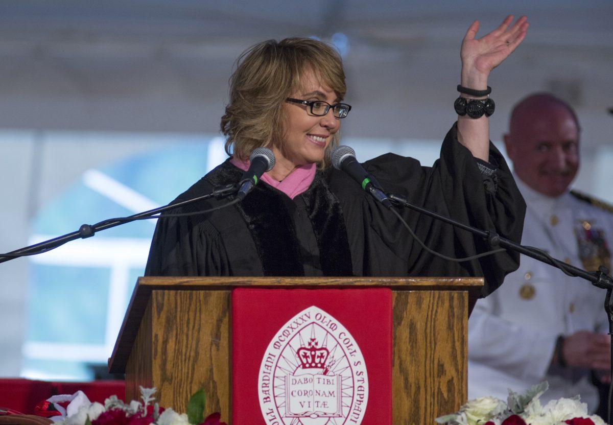 Former U.S. Rep. Gabrielle Giffords and her husband, retired space shuttle Commander Mark Kelly, background right, acknowledge the crowd after delivering the commencement address in two parts, during the 153rd Commencement at Bard College, Saturday, May 25, 2013, in Annandale-on-Hudson, N.Y. Giffords also received an honorary degree. (AP Photo/Philip Kamrass)