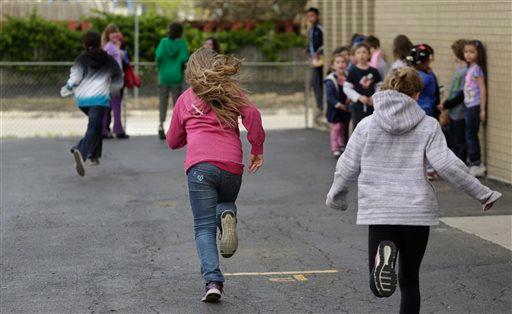 Ryan, a "gender variant" fourth grader, center, runs with others during recess at their school in Illinois on May 2, 2013. (AP Photo/M. Spencer Green)