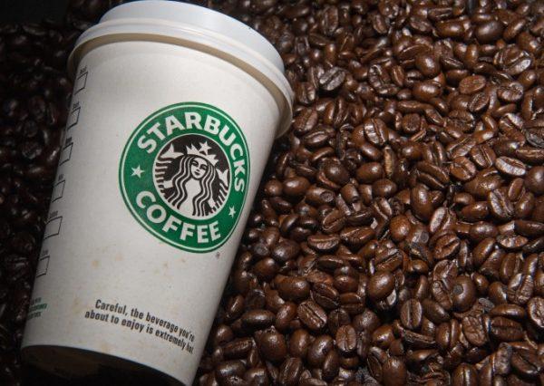 A Starbucks coffee cup and beans are seen. (Paul J. Richards/AFP/Getty Images)
