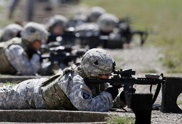 Soldiers from 1st Brigade Combat Team, 101st Airborne Division, train on a firing range while testing new body armor in Fort Campbell, Ky., in preparation for deployment to Afghanistan. File photo taken on Sept. 18, 2012. (Mark Humphrey/AP)