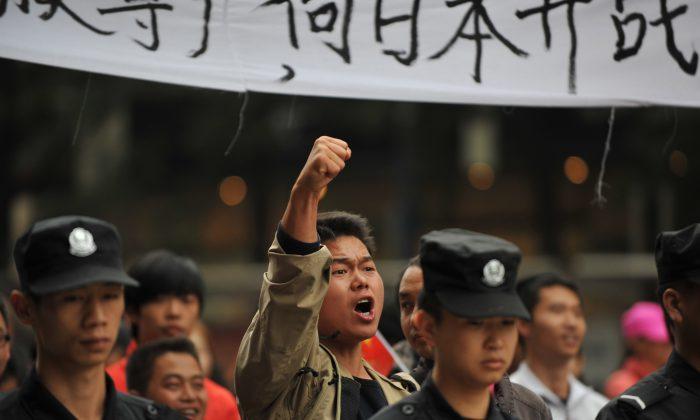 A Chinese demonstrator shouts slogans during a protest against Japan's "nationalizing" of the Diaoyu Islands, also known as the Senkaku Islands in Japan, in Kunming, Yunnan Province, China, on Sept. 18, 2012. (STR/AFP/GettyImages)