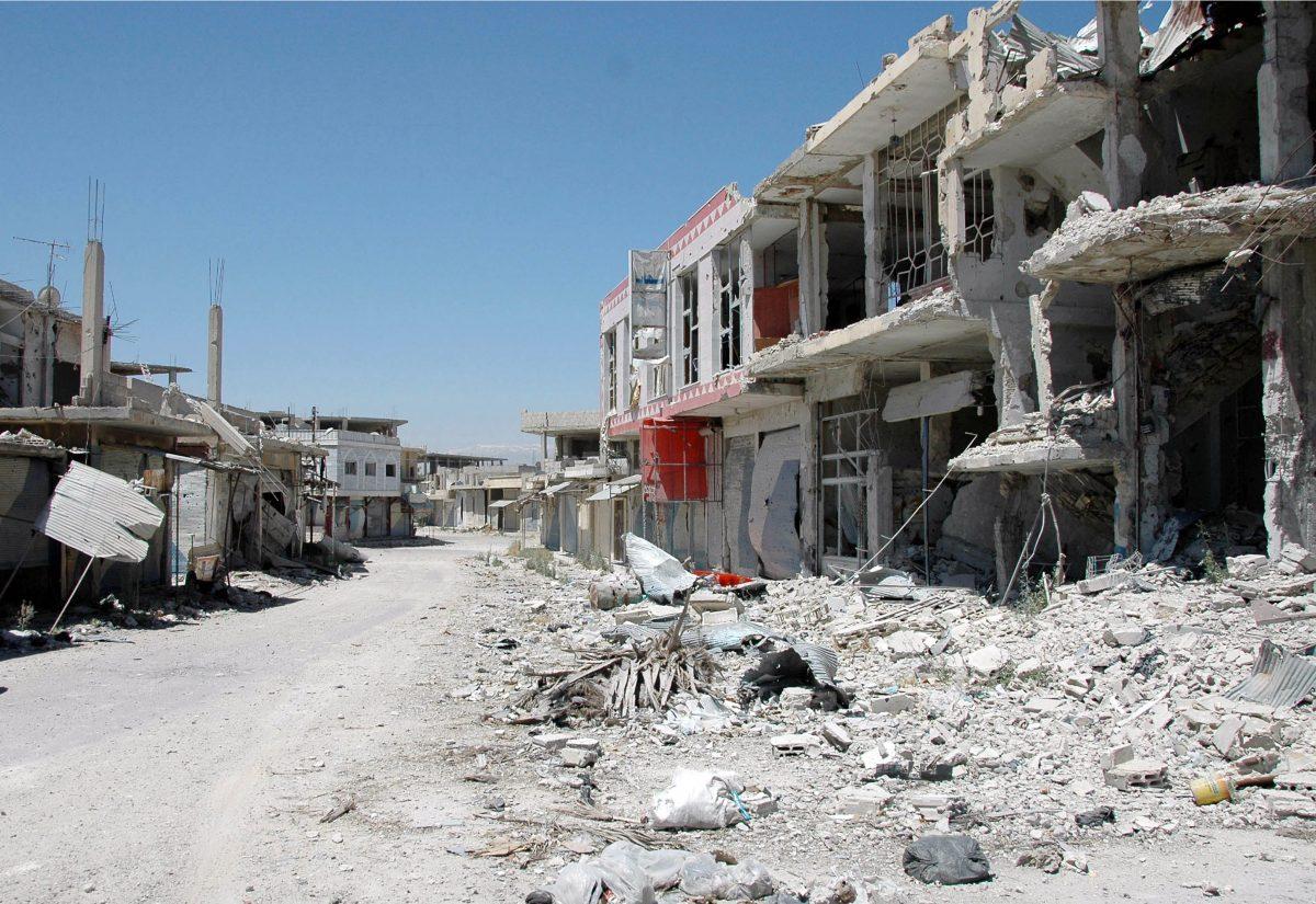 In this June 5, 2013, file photo released by the Syrian official news agency SANA, a damaged street is seen in Qusair, Syria. Syria's civil war has morphed into a proxy fight in which Shiite Iran has strongly backed Assad, while Sunni Arab nations have backed rebels. (AP Photo/SANA, File)