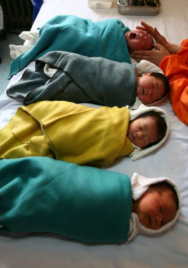 A nurse massages babies at the Xining Children Hospital in Xining City, Qinghai Province, China. Hospitals in Henan province have been advertising the selling of unwanted babies, according to a report by China National Radio. (Getty Images)