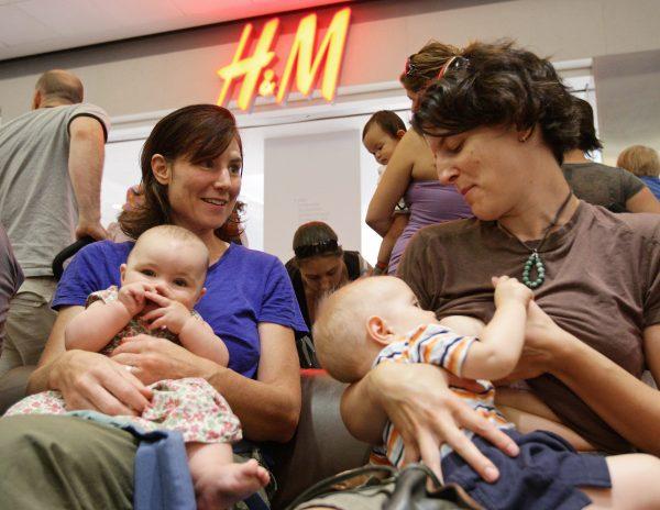 A woman nurses her son outside an H&M store in Vancouver in August 2008. (The Canadian Press/Darryl Dyck)