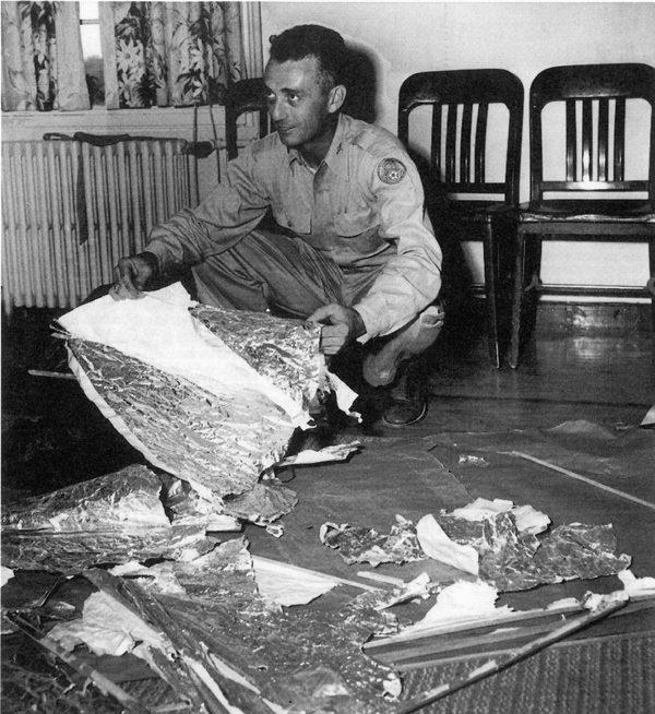 Maj. Jesse Marcel from the Roswell Army Air Field with debris found 75 miles northwest of Roswell, N.M., in June 1947.  (United States Air Force/AFP/Getty Images)