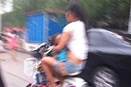 Chinese Mother Arrested for Breastfeeding on Moped