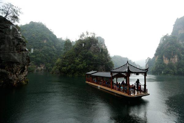 Tourists are seen on sightseeing cruises at the Baofeng Lake in Zhangjiajie, China, on Sept. 1, 2013. (Lintao Zhang/Getty Images)