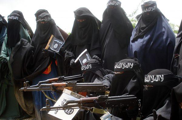 Somali women carry weapons during a demonstration organized by the Extremist group, Al-Shabaab, which is fighting the Somali government in Suqa Holaha neighborhood of Mogadishu, on July 5, 2010. (Abdurashid Abikar/AFP/Getty Images)