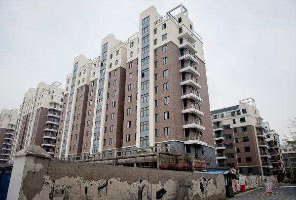 A group of apartments that were built in Hangzhou, capital of Zhejiang Province, sit vacant, as the construction company has gone bankrupt, on April 10, 2012. Also in Hangzhou, the developer China Metallurgical Group Corporation faces huge losses, as the local governments do not have the money to pay off debts to the company. (STR/AFP/Getty Images)