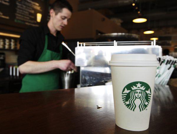 A Starbucks drink waits for a customer to pick it up a barista prepares another at Starbucks in on April 27, 2012. (Ted S. Warren/AP Photo)