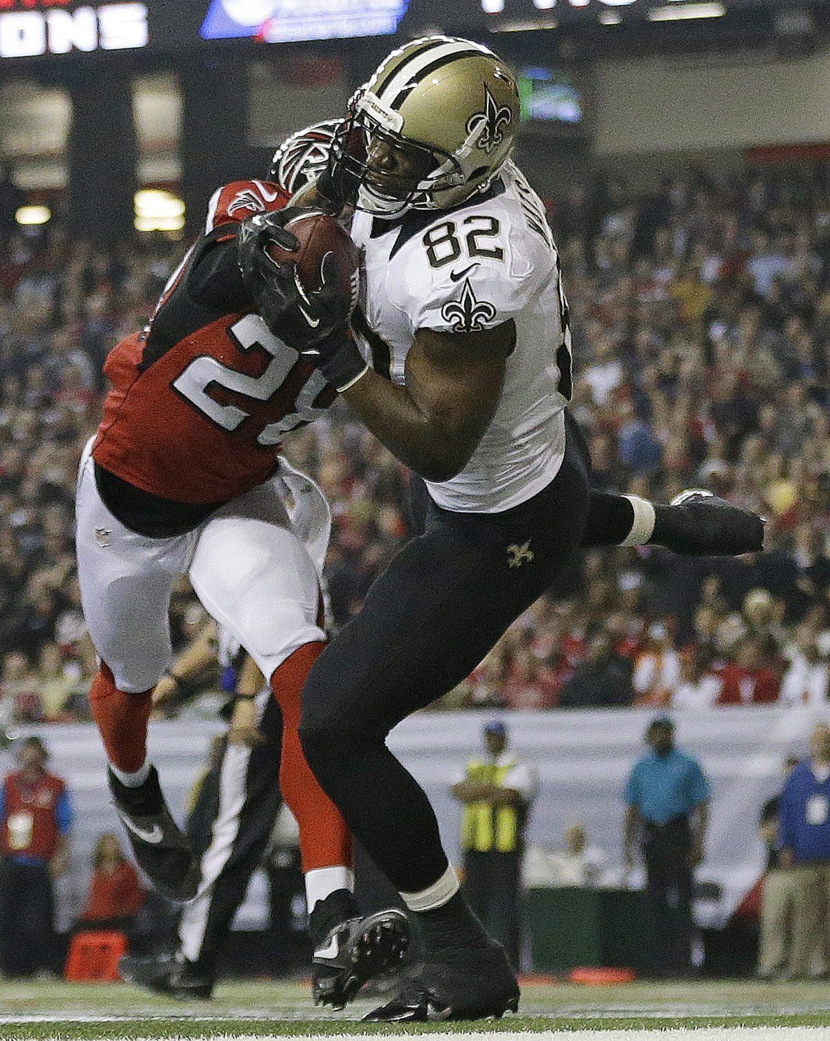 New Orleans Saints tight end Benjamin Watson (82) makes a touch-down catch against Atlanta Falcons free safety Thomas DeCoud (28) during the first half of an NFL football game, Thursday, Nov. 21, 2013, in Atlanta. (AP Photo/David Goldman)