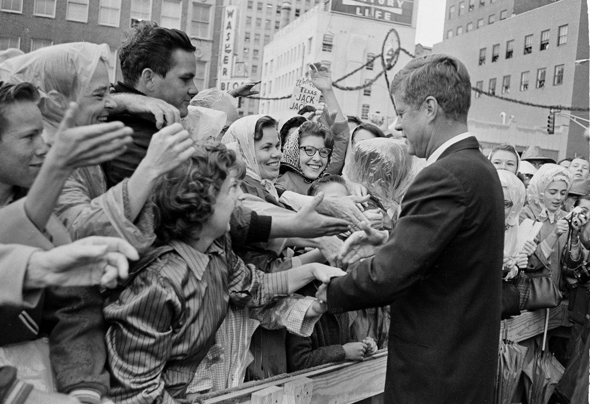President John F. Kennedy is greeted by an enthusiastic crowd in front of the Hotel Texas in Fort Worth, Texas, on Nov. 22, 1963, just hours before he was assassinated. (AP Photo)