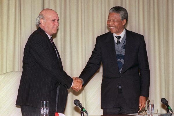 A file image of South African President Frederik W. de Klerk and African National Congress (ANC) representative Nelson Mandela at a joint press conference on Aug. 7, 1990, in Pretoria, South Africa. (Alexander Joe/AFP/Getty Images)