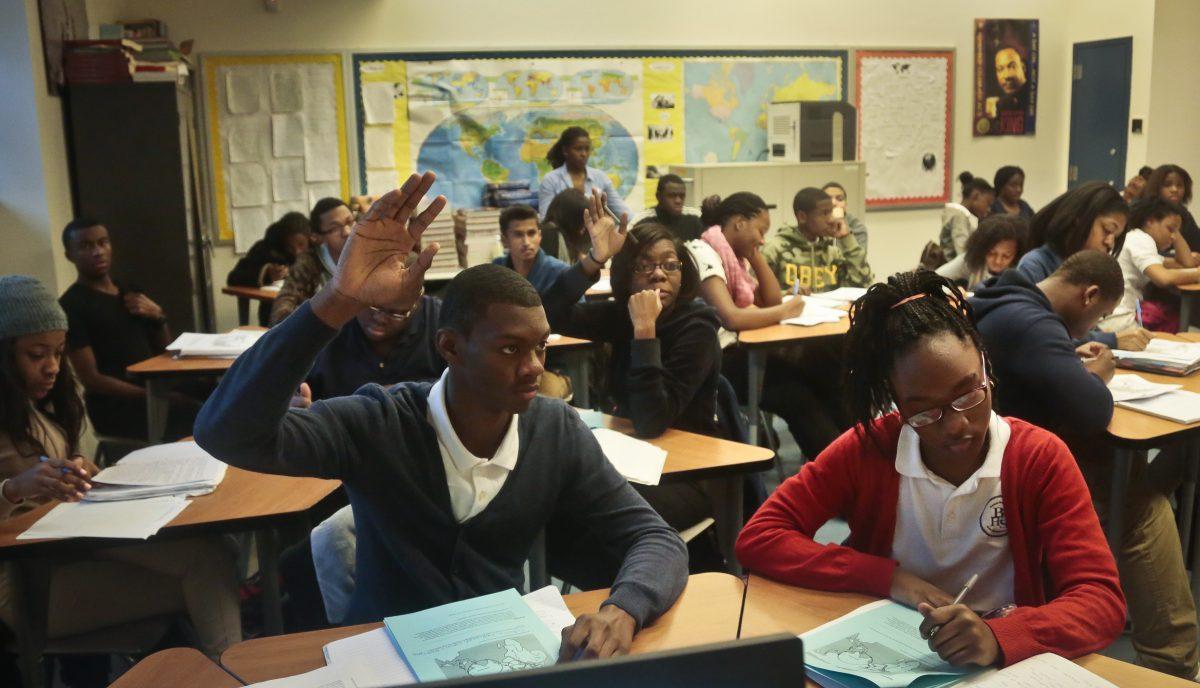 In this file photo students raise hands during a Global Studies class of 10th- and 11th-graders at Bedford Academy High School in New York on Dec. 3, 2013. (Bebeto Matthews/AP)