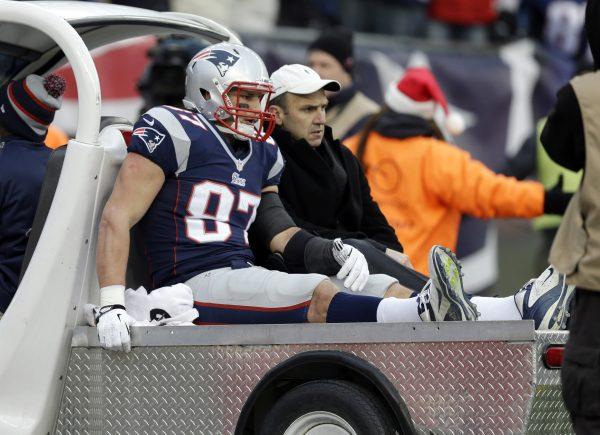In this Sunday, Dec. 8, 2013, file photo, New England Patriots tight end Rob Gronkowski is carted off the field after getting injured. (AP Photo/Steven Senne, File)