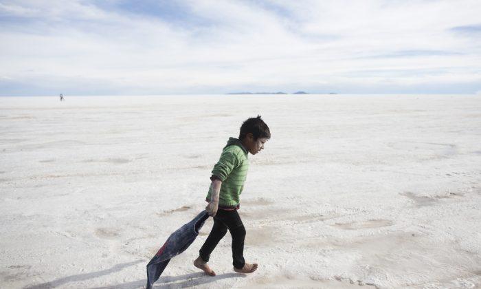  Rafael, 7, walks on the Uyuni Salt Flat after bathing in a hole with salty water in Uyuni, Bolivia, in 2014. (AP Photo/Victor Caivano)