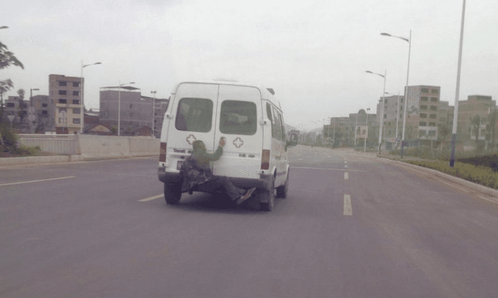 Chinese Man Escapes on Back of Ambulance