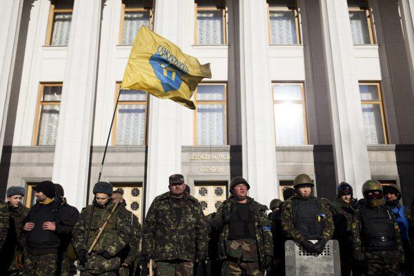 Self-defense volunteers line up outside the Parliament in Kyiv, Ukraine, on March 17, 2014. A referendum held in Crimea was widely condemned by Western leaders planning to discuss economic sanctions to punish Russia. (David Azia/AP Photo)