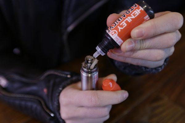 A liquid nicotine solution is poured into a vaping device at the Henley Vaporium in New York, on Feb. 20, 2014. (Frank Franklin II/AP Photo)