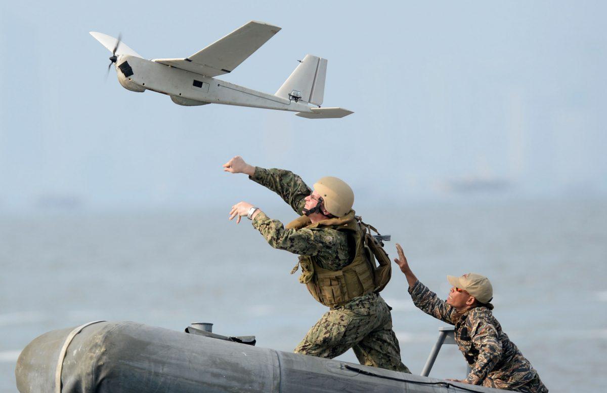 U.S. (L) and Philippine navy personnel launch an unmanned aerial vehicle (UAV) from a speed boat west of Manila as part of joint exercises on June 28, 2013. The annual exercises were held off the west coast of the Philippines' main island of Luzon, close to Scarborough Shoal, which China insists it owns. (Ted Aljibe/AFP/Getty Images)
