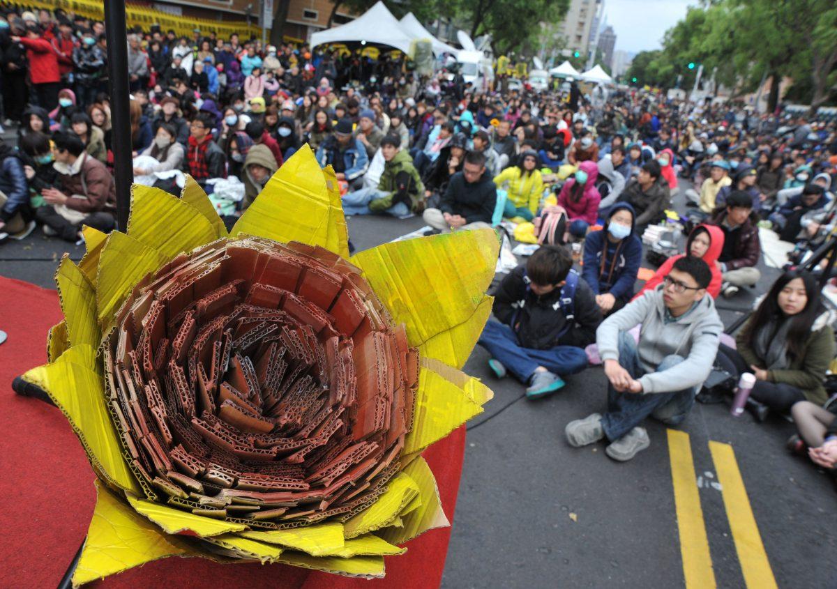 A paper sunflower in the foreground as activists rally outside Taiwan's parliament to support student protesters occupying the building in Taipei on March 21, 2014. (Mandy Cheng/AFP/Getty Images)
