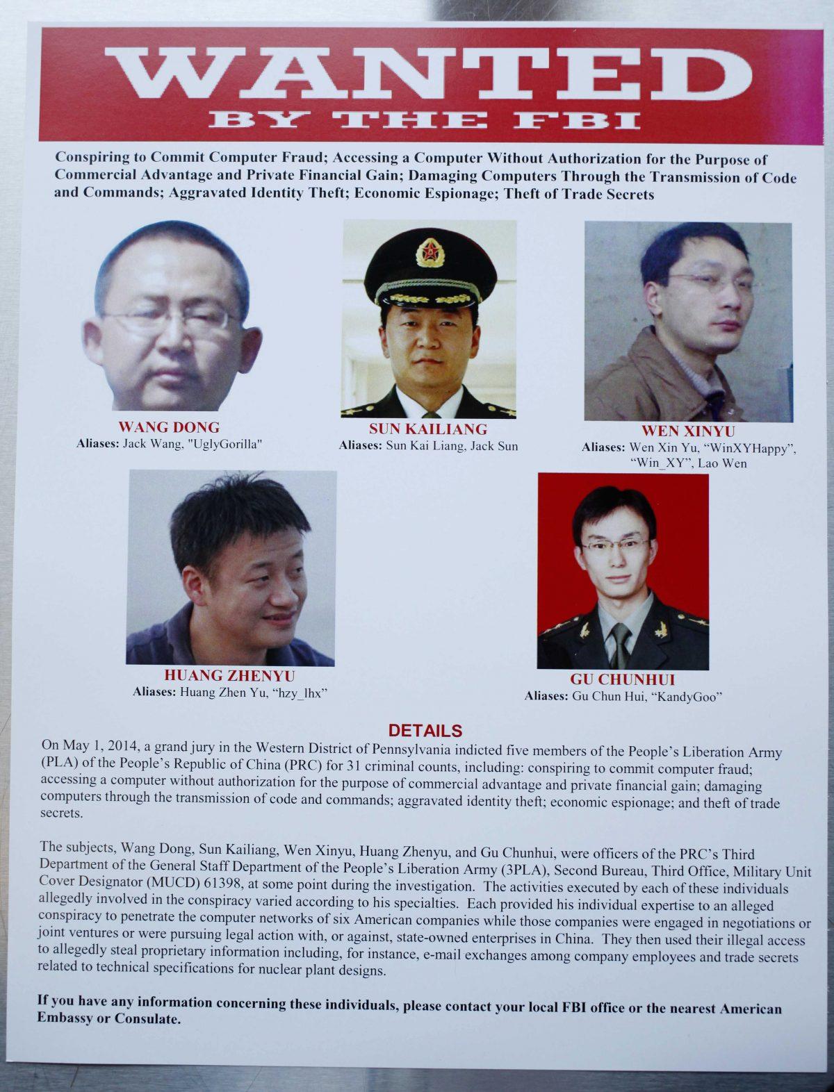 This wanted poster is displayed at the Justice Department in Washington on May 19, 2014. Then-Attorney General Eric Holder announced that a U.S. grand jury charged five Chinese hackers with economic espionage and trade secret theft, the first-of-its-kind criminal charges against Chinese military officials in an international cyber-espionage case. (AP Photo)